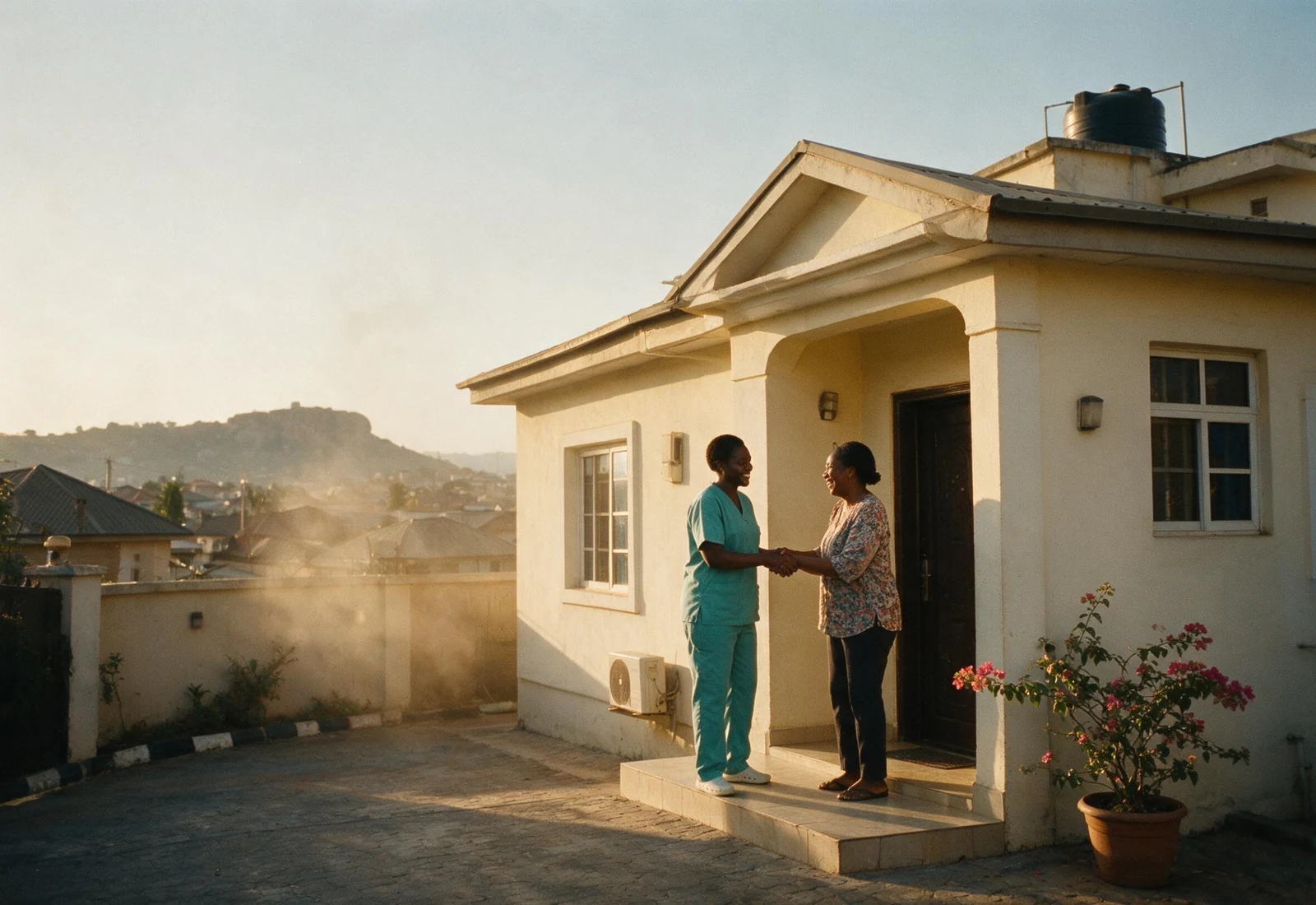 A home visit in a Gwarinpa estate in Abuja, with distant haze over the hills.