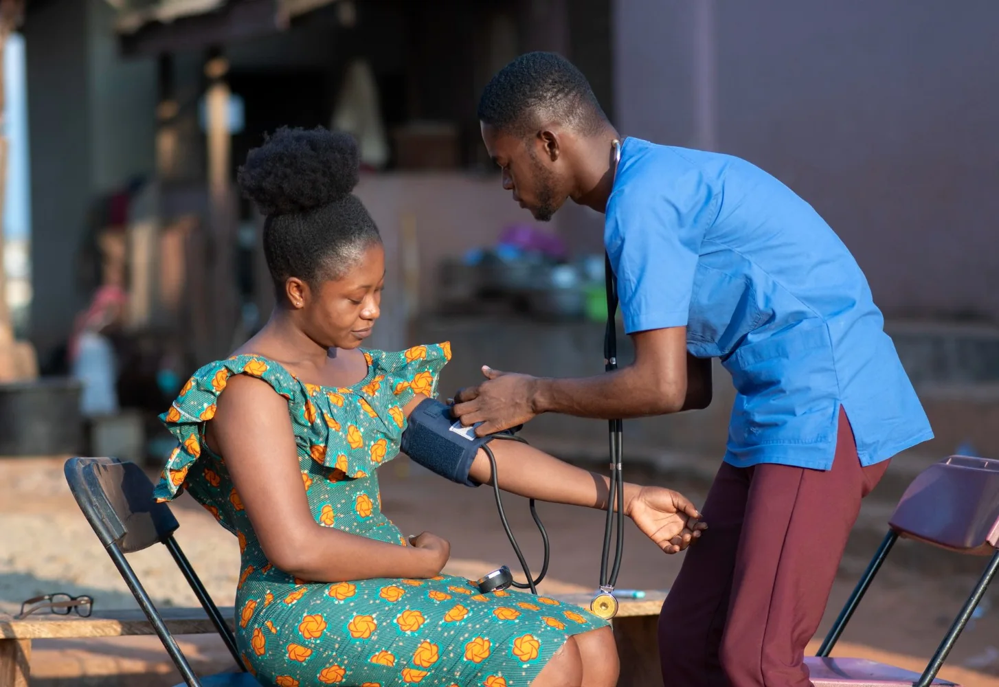 An Insyt clinician reviews a health check with a client at home, unhurried and clear.